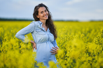 Pregnant woman in a canola field