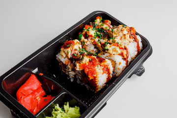 Japanese food: maki and nigiri sushi set. Sushi rolls with rice, fish salmon, smoked eel, avocado, cream cheese, soy Teriyaki sauce, sesame. Chopsticks, wasabi and Pickled Ginger.