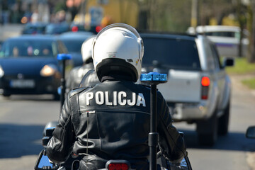 Policjant wydziału ruchu drogowego z motocyklem podczas kontroli miasta.  - obrazy, fototapety, plakaty