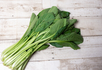Bok choy on wooden floor, Bok choy or Chinese-cabbage on wooden board and wooden floor.Bok choy is the best leafy green vegetable.