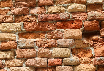 ruined red brick wall background of a rustic abandoned building