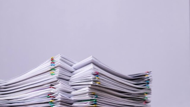 4K Stop motion Key Frame of stack overload document report paper with paperclip place decrease on white background, business and education concept footage paperless used.