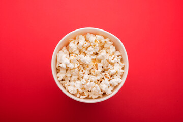 Heap of delicious popcorn isolated on background. Scattered popcorn texture background. Selective focus.