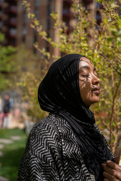 Portrait of a Black Muslim woman with shadows on her face