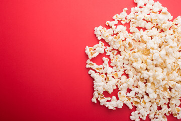 Heap of delicious popcorn isolated on background. Scattered popcorn texture background. Selective focus.