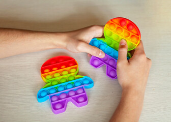 Young man playing with fidget sensory toy to relieve stress, simple way to be in calm and harmony, mental health concept