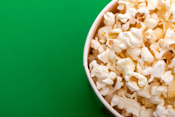 Heap of delicious popcorn isolated on background. Scattered popcorn texture background. Selective focus.
