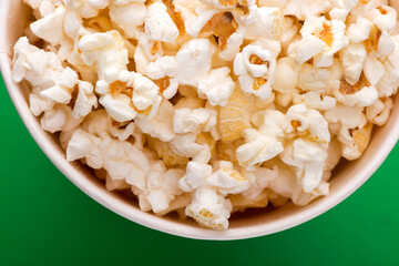 Heap of delicious popcorn isolated on background. Scattered popcorn texture background. Selective focus.