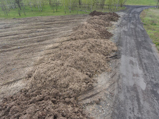 Large heap pile of construction soil mud land earth dirt heap pile, freshly digged, mixed with some...