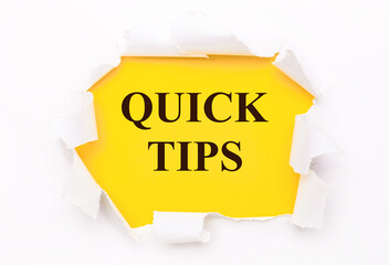 Torn white paper lies on a bright yellow background with the text QUICK TIPS