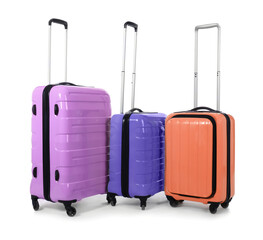 Stylish suitcases packed for travel on white background