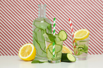 Lemon cucumber water with colorful paper straw. Healthy detox drink. 