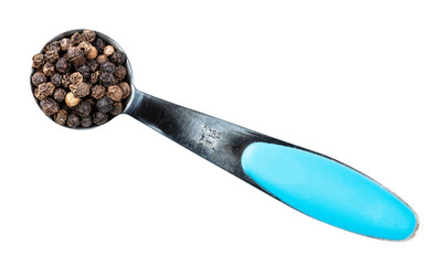 black pepper peppercorns in measuring spoon cutout