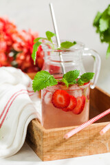 Homemade refreshing strawberry lemonade in pitcher and glass