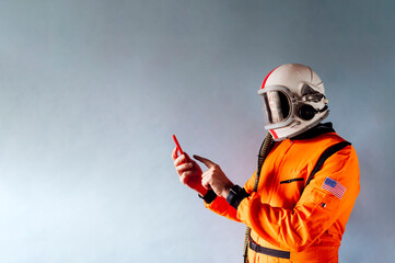 Man in astronaut suit with a smartphone.