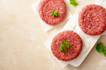 Meat for burgers. Raw cotlests to cook burgers. Cooking homemade meat sandwitches. Top view, copy space.