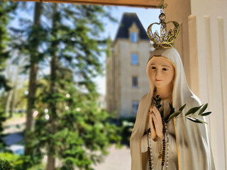 Virgin Mary statue praying with her hands joined ,with a crown. Our Lady of Fatima. Paray-le-Monial, France.