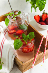 Homemade refreshing strawberry lemonade in pitcher and glass