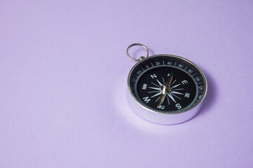 Compass on purple background. Concept signs symbols.