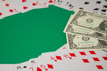 Classic playing cards and dollars on green background. Gambling and casino concept.