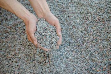 Man holding small rubble in his hands selective focus