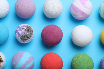 Colorful bath bombs on light blue background, flat lay