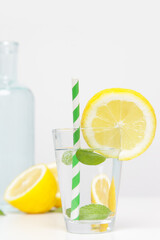 Lemonwater with colorful paper straw. Healthy detox drink. 