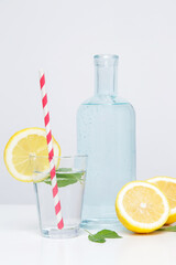 Lemonwater with colorful paper straw. Healthy detox drink. 