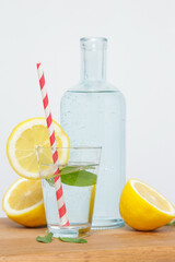 Lemonwater with colorful paper straw. Healthy detox drink. 
