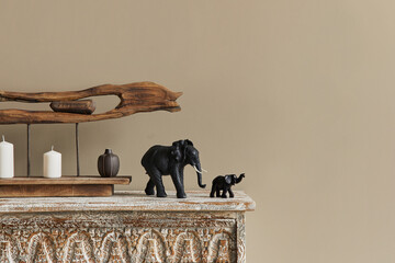 Stylish composition at moroccan interior with wooden shlef, candles, design elephant figure and...