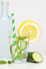 Lemon cucumber water with colorful paper straw. Healthy detox drink. 