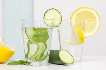 Lemon cucumber water with colorful paper straw. Healthy detox drink. 