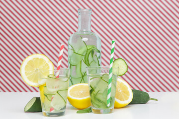 Lemon cucumber water with colorful paper straw. Healthy detox drink. 