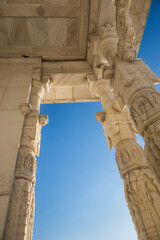 A below angle view of an Indian temple with intricate stone carving work. Details from old Indian historic architecture.