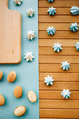 Confectionery for coffee on a wooden table. White marshmallows and shortcrust pastry cookies. 