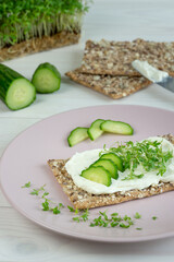 crisp bread with cream cheese on a plate cress cucumber