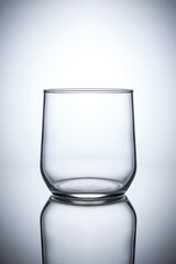empty whiskey glass on white background with reflection isolated