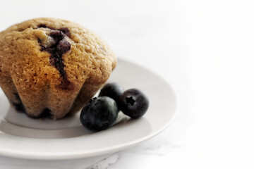 Close up of homemade blueberry muffin. High key shot with white background.