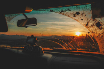 Offroad car trip through the Ukrainian Carpathians in spring. View from the window. External expedition. Sunset car view
