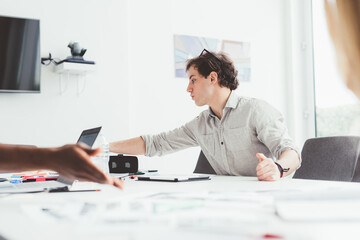 Millennial businessman joining meeting using tablet
