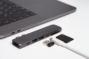 Close-up photo of laptop, type-c hub with cable and usb receiver