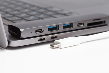 Close-up photo of type-c hub, type-c cable and laptop