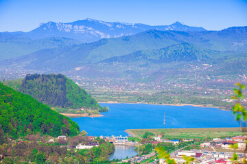Fototapeta na wymiar Lake and Ceahlau mountain seen from Piatra Neamt city, Romania