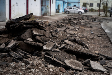 A close-up of the broken asphalt. Repair work with the replacement of the road surface