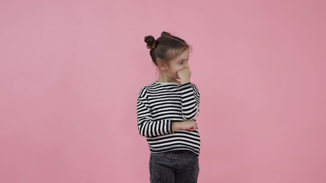 Little girl dreaming about the future. Little girl daydreaming. Having idea. Hand on chin. Wrighting idea down.