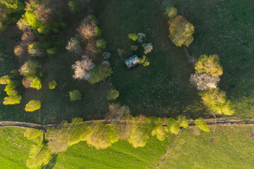 Rural mountain landscape with remote Romanian village uphill in the valleys of Carpathian mountains, in springtime