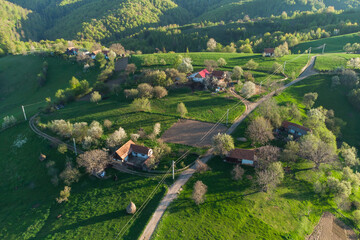 Rural mountain landscape with remote Romanian village uphill in the valleys of Carpathian...
