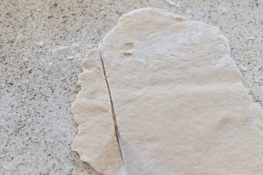 Freshly Rolled Dough Being Cut Into Strips To Make Homemade Chicken And Dumplings, A Southern Recipe Favorite.