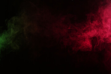 Smoke in red-green light on black background