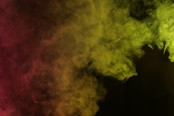 Obraz na płótnie Canvas Smoke in red-yellow light on black background
